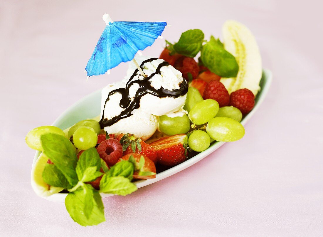 Fresh fruit with vanilla ice cream and cocktail umbrella