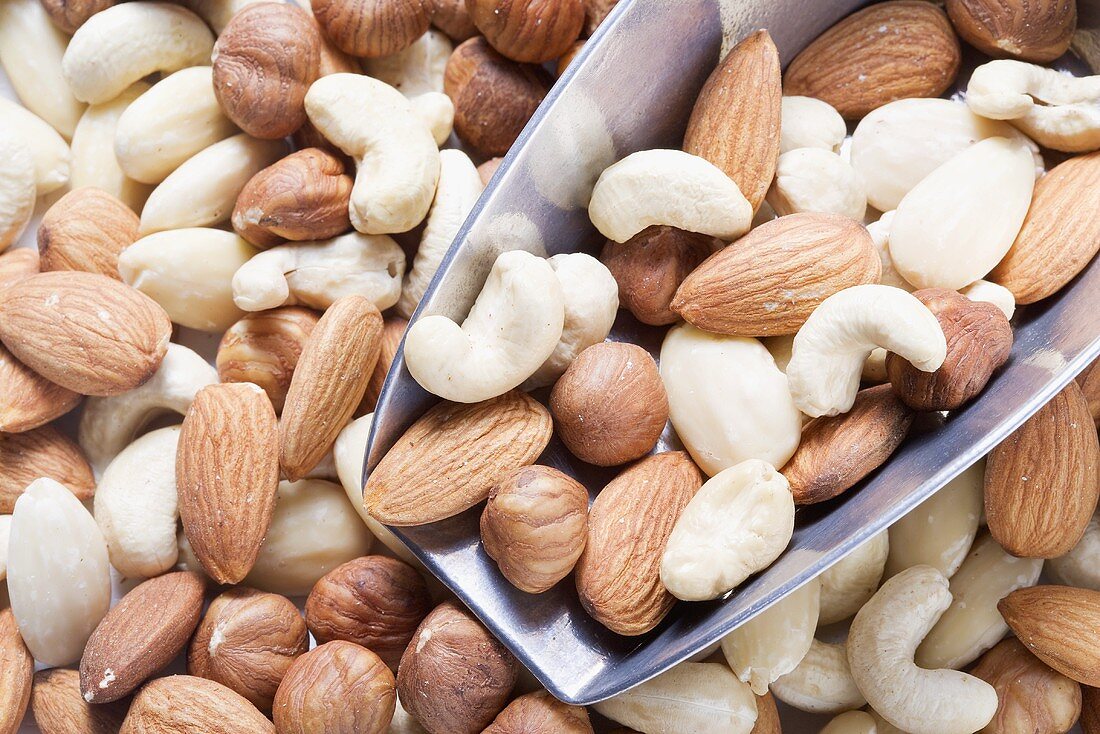 Assorted nuts, some in metal scoop