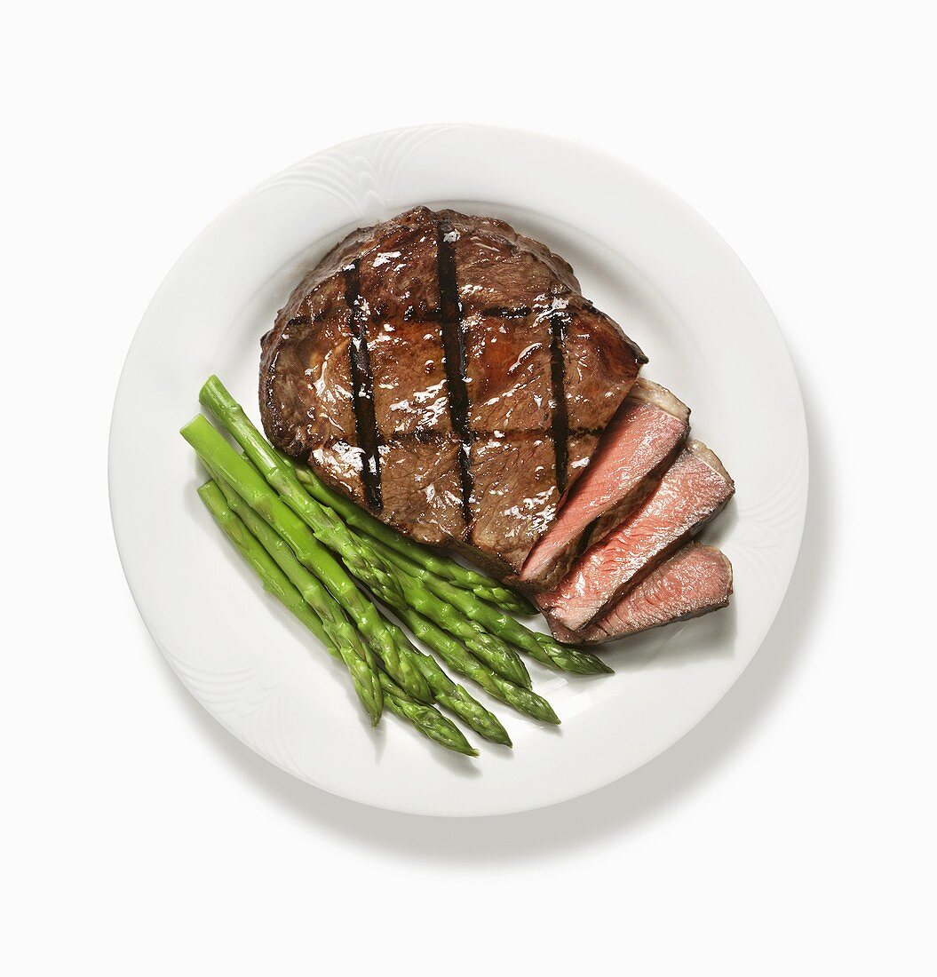 Partially Sliced Grilled Steak with Asparagus; From Above