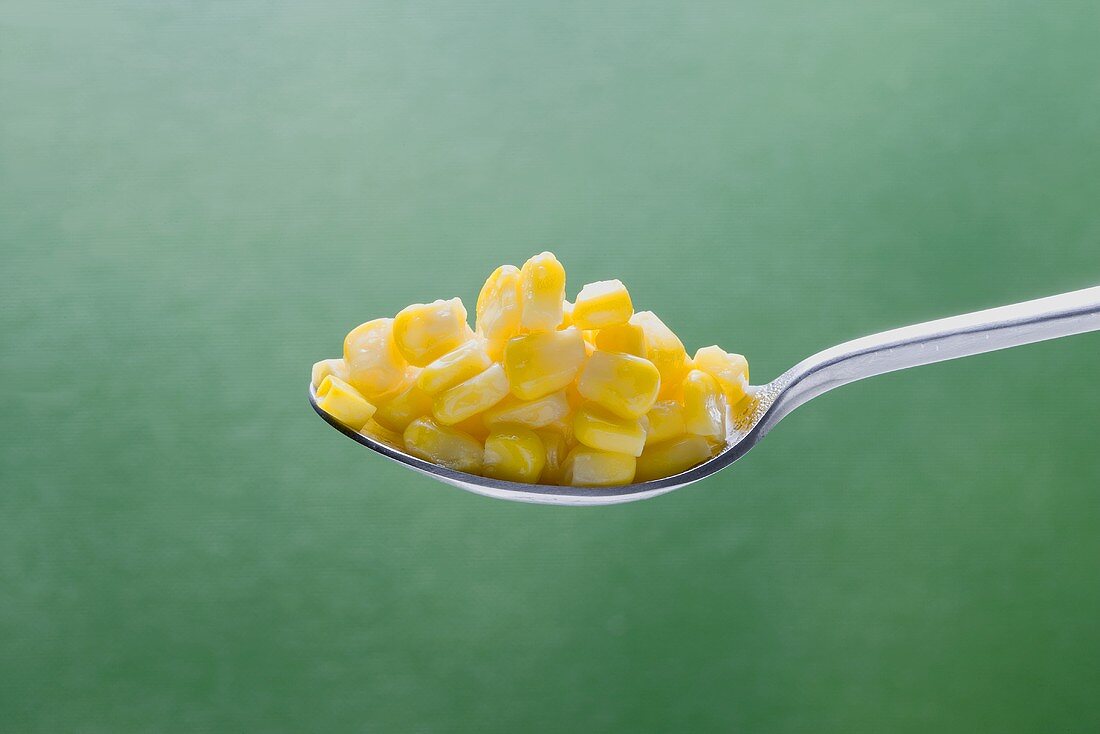 Sweetcorn kernels on spoon