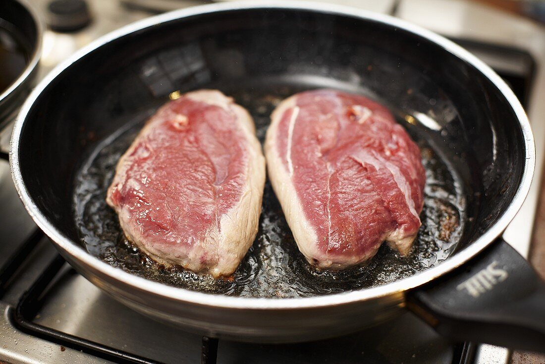 Frying duck breast, skin-side down