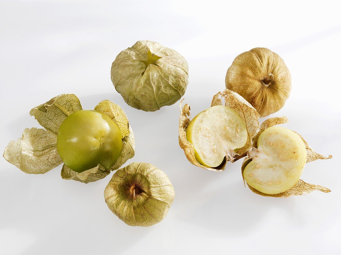 Several tomatillos, whole and halved