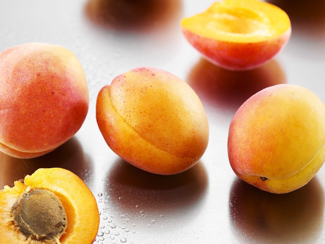 Several apricots, whole and halved