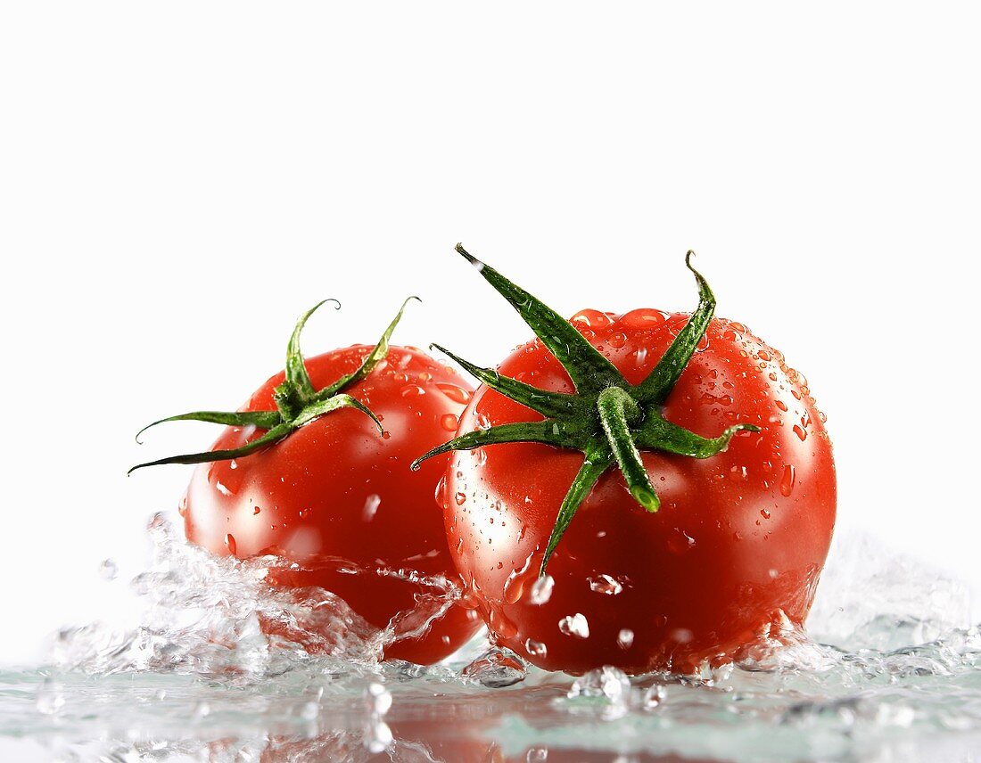 Two tomatoes surrounded with water