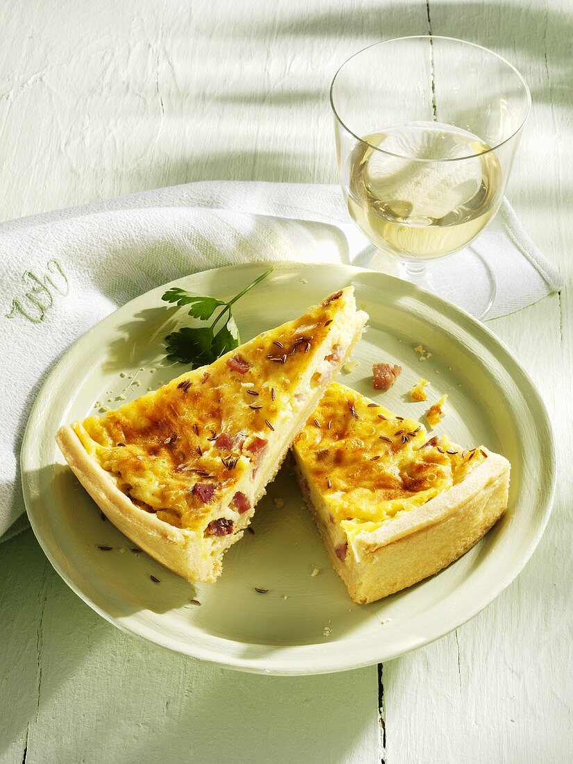 Spicy cheese and caraway seed tart with a glass of white wine