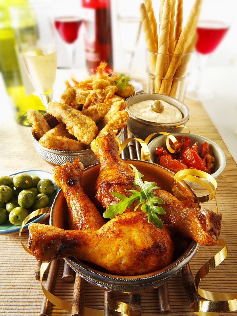 Party buffet with chicken drumsticks