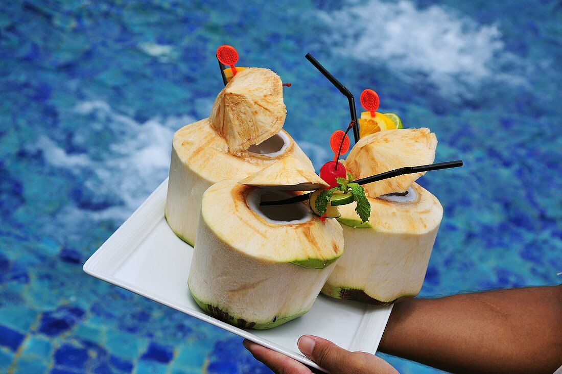 Coconuts with straws on a platter