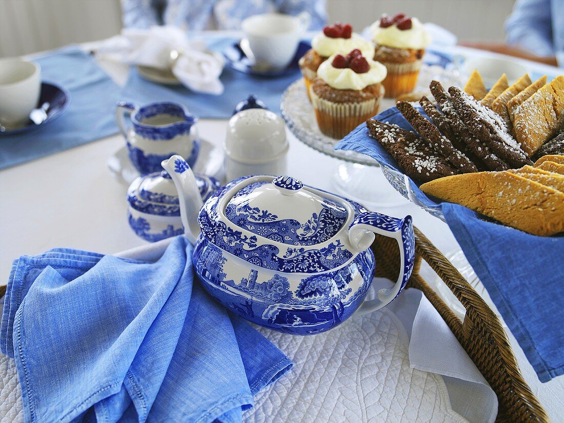 Tea and cakes on laid table