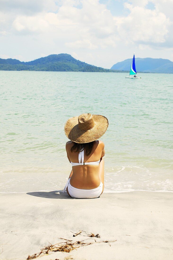 Woman in sunhat by sea (Malaysia)