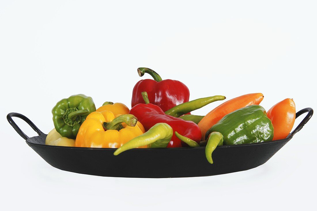 Fresh peppers and chillies in frying pan