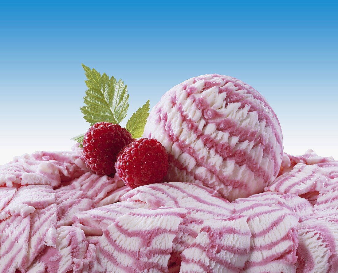 Raspberry ice cream and two fresh raspberries