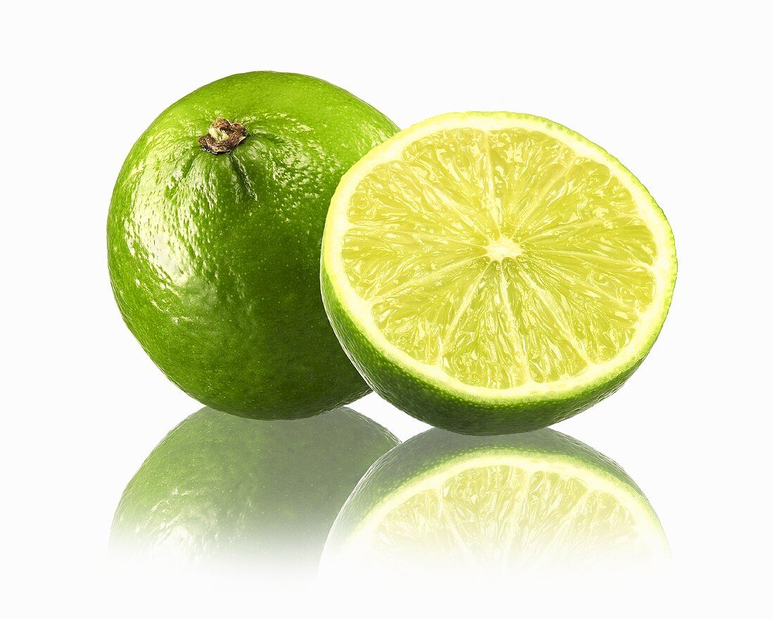 Whole lime and half a lime with reflection