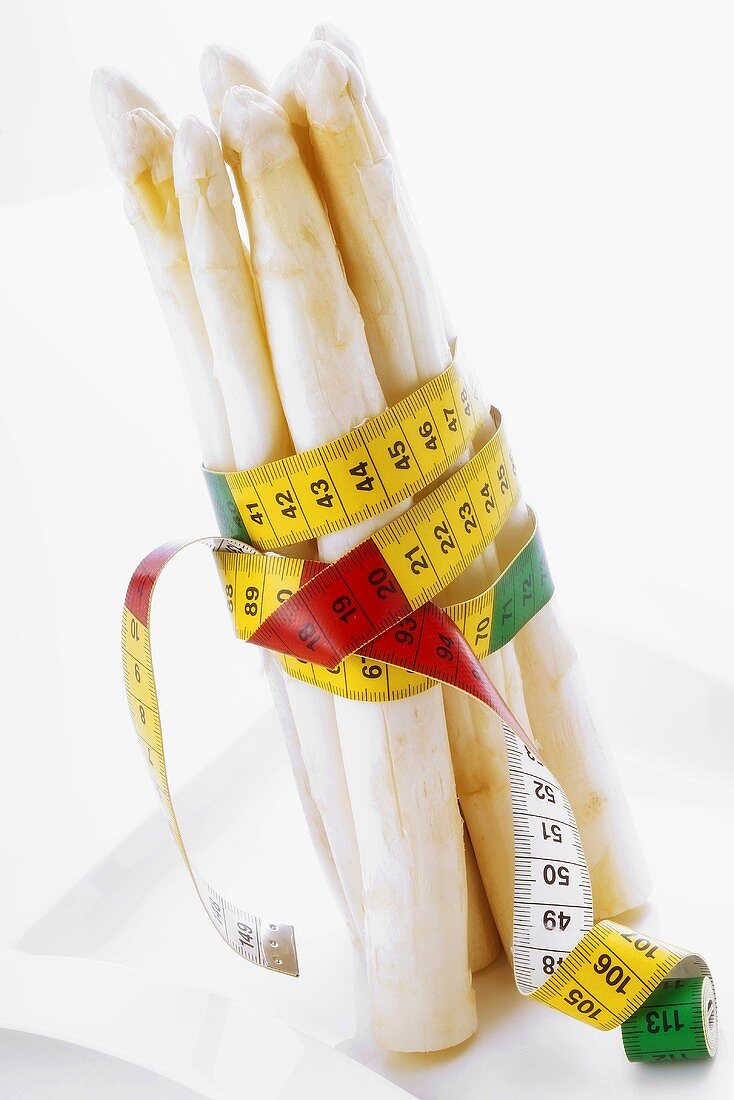 White asparagus wrapped in tape measure