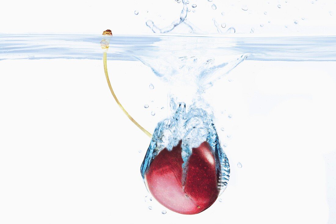 Cherry falling into water
