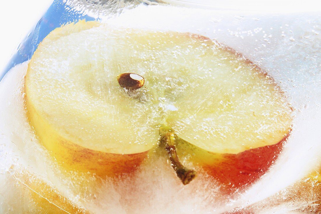 Frozen apple half in block of ice