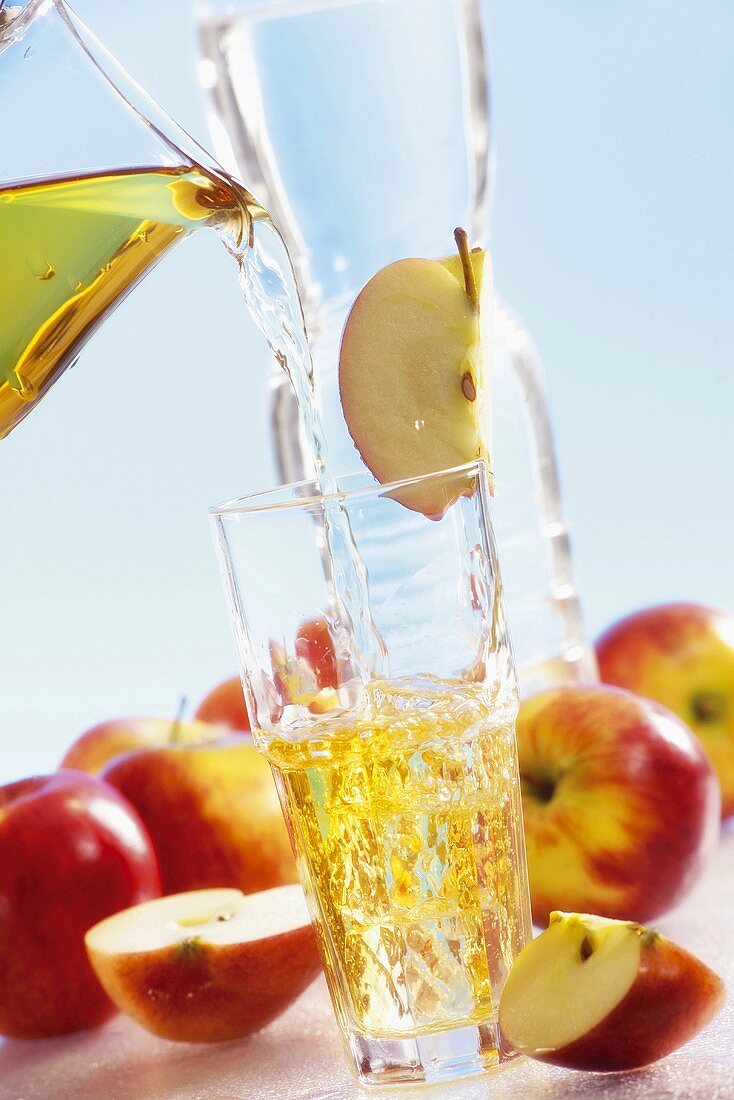 Pouring apple juice into glass