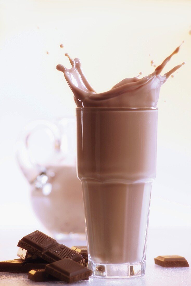 Hot chocolate splashing out of glass