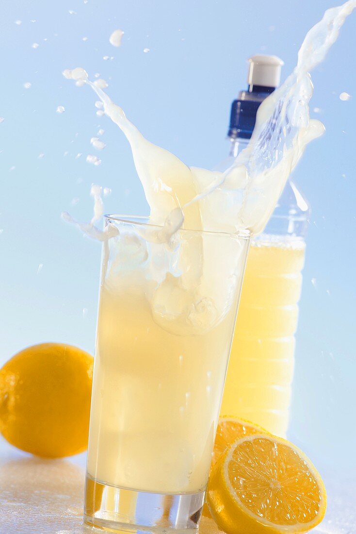 Lemonade splashing out of glass