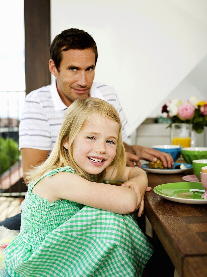 Father and daughter at breakfast table