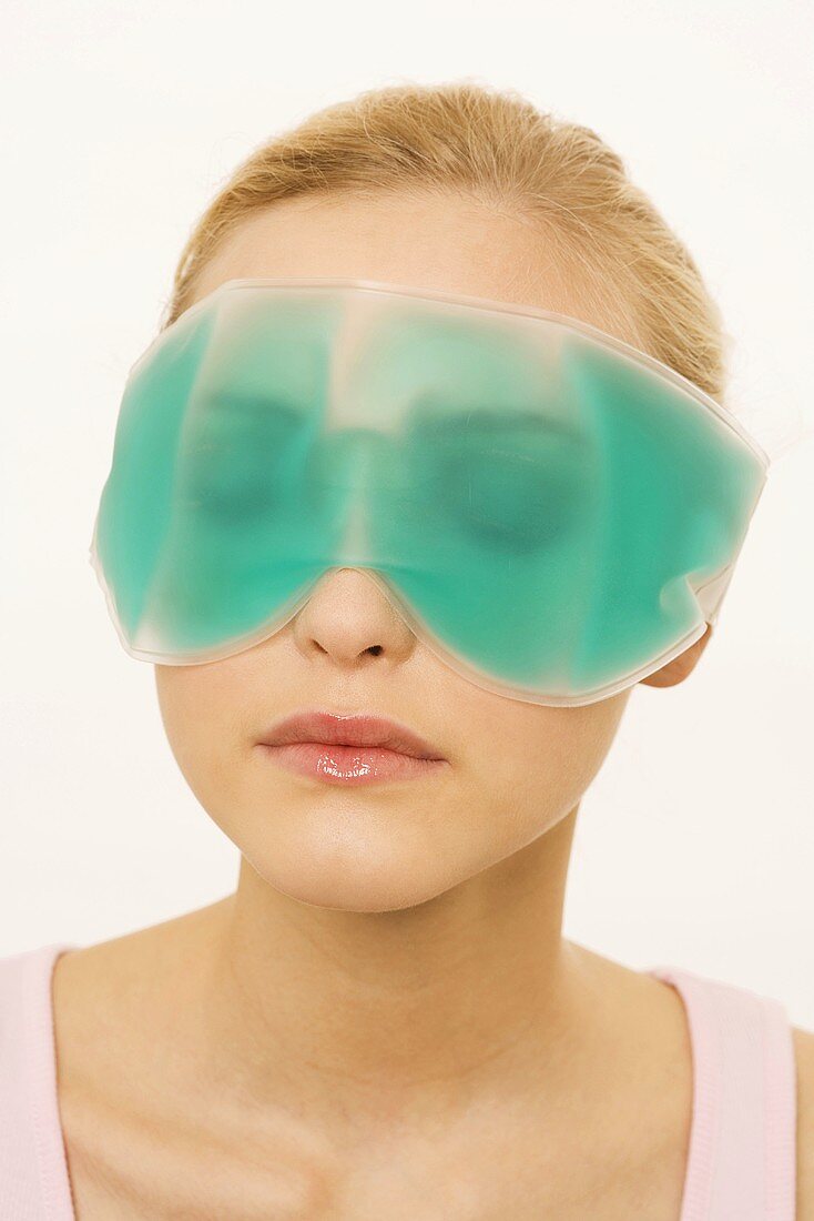 Young Woman Wearing a Gel Eye Mask, portrait