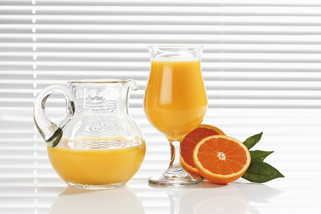 Orange juice in glass and glass jug