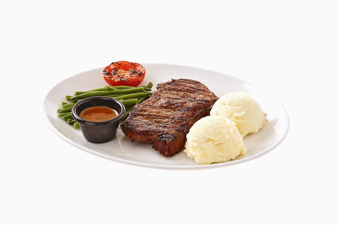 Beefsteak with mashed potato, beans, grilled tomato & sauce
