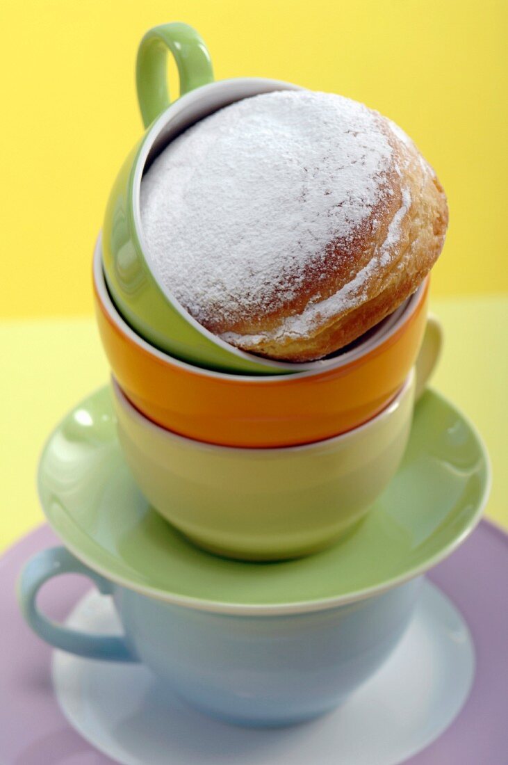 Cruller on top of cups, close-up