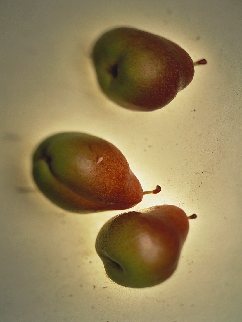 Three pears on sheet of glass