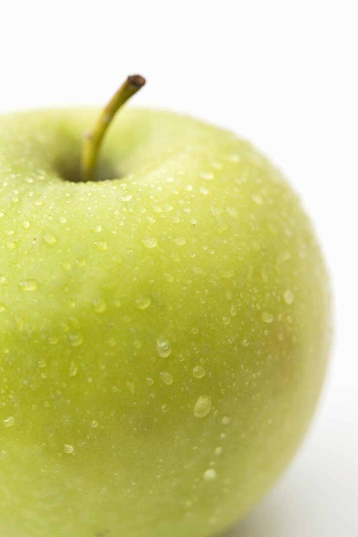 Green apple with drops of water