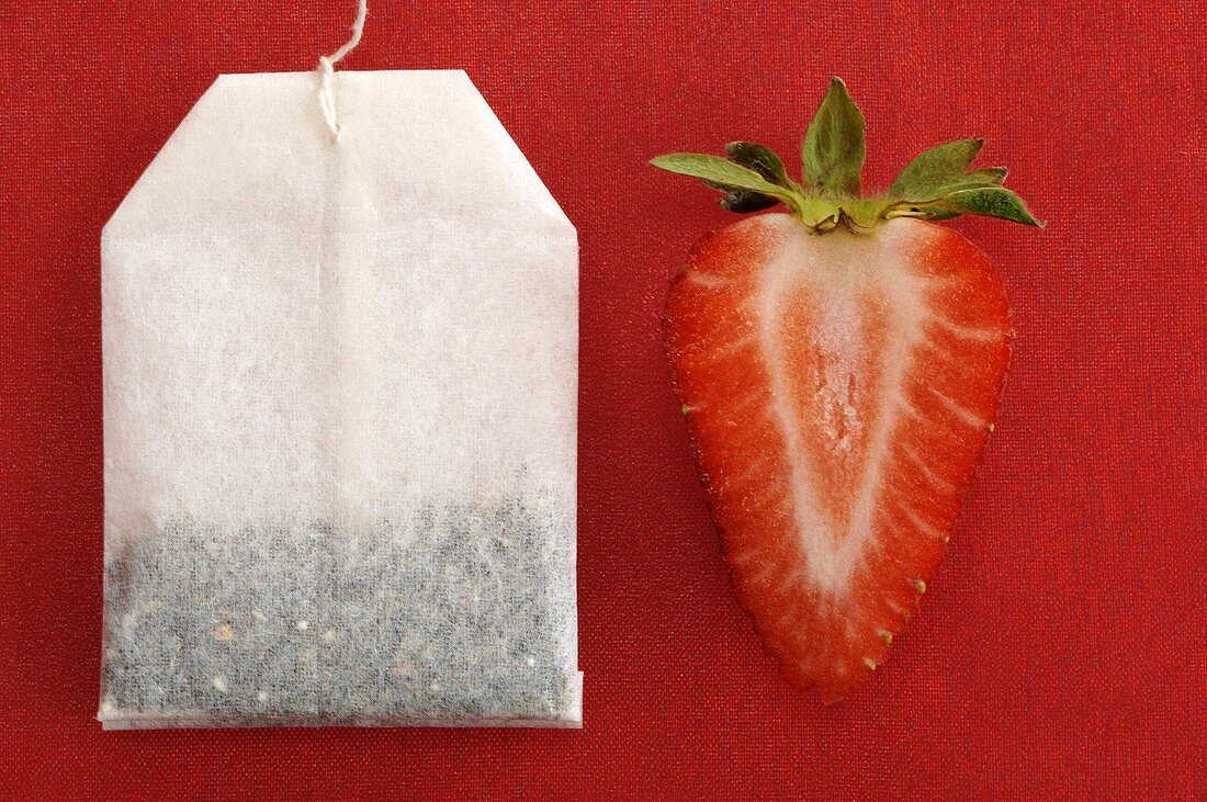 Sliced strawberry by tea bag
