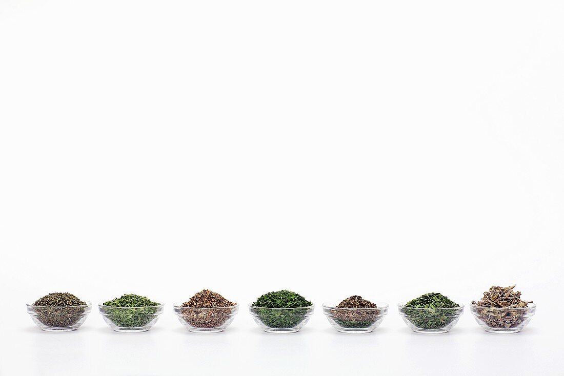 Dried herbs in bowls, close-up