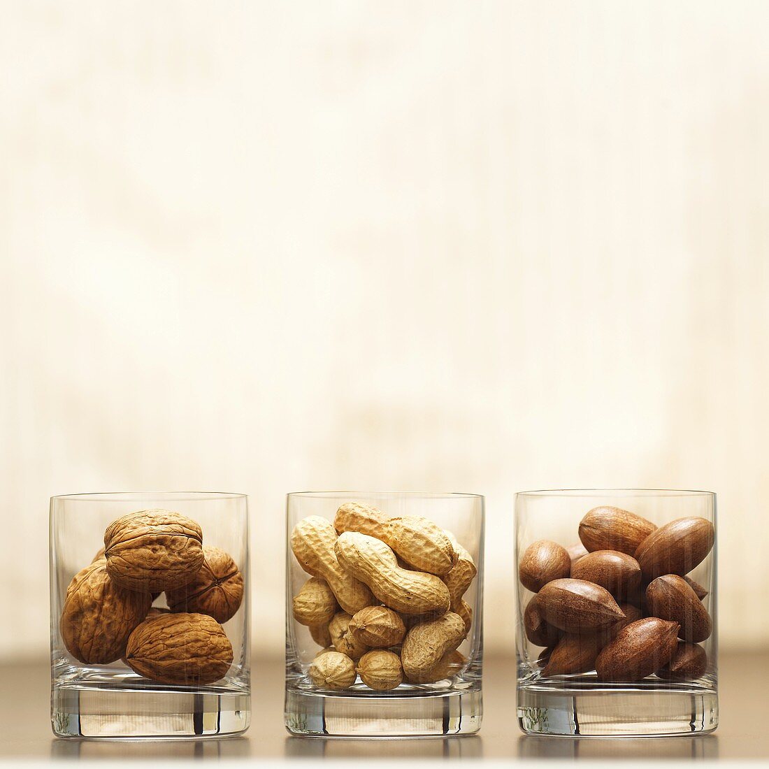 Different types of nuts in glasses