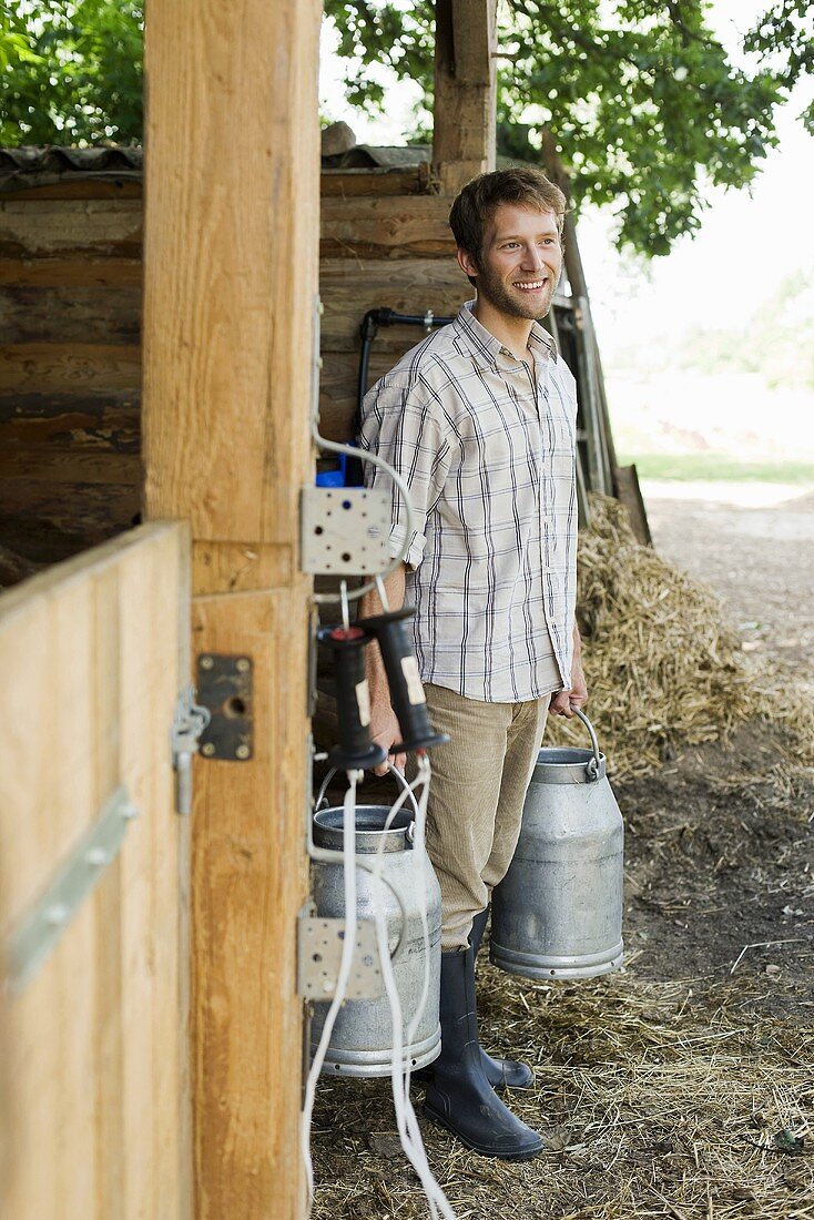 Farmer carrying milk cans