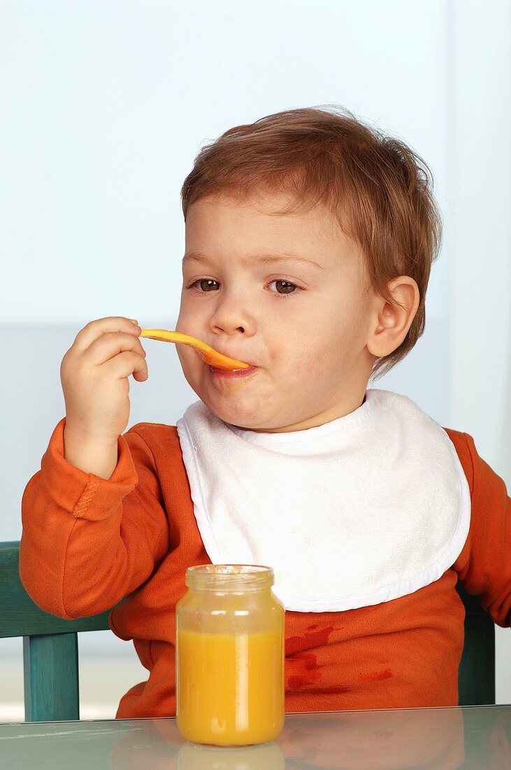 Toddler eating baby food