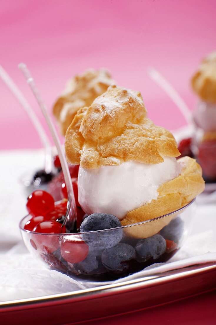 Cream puffs with wild berries, close-up