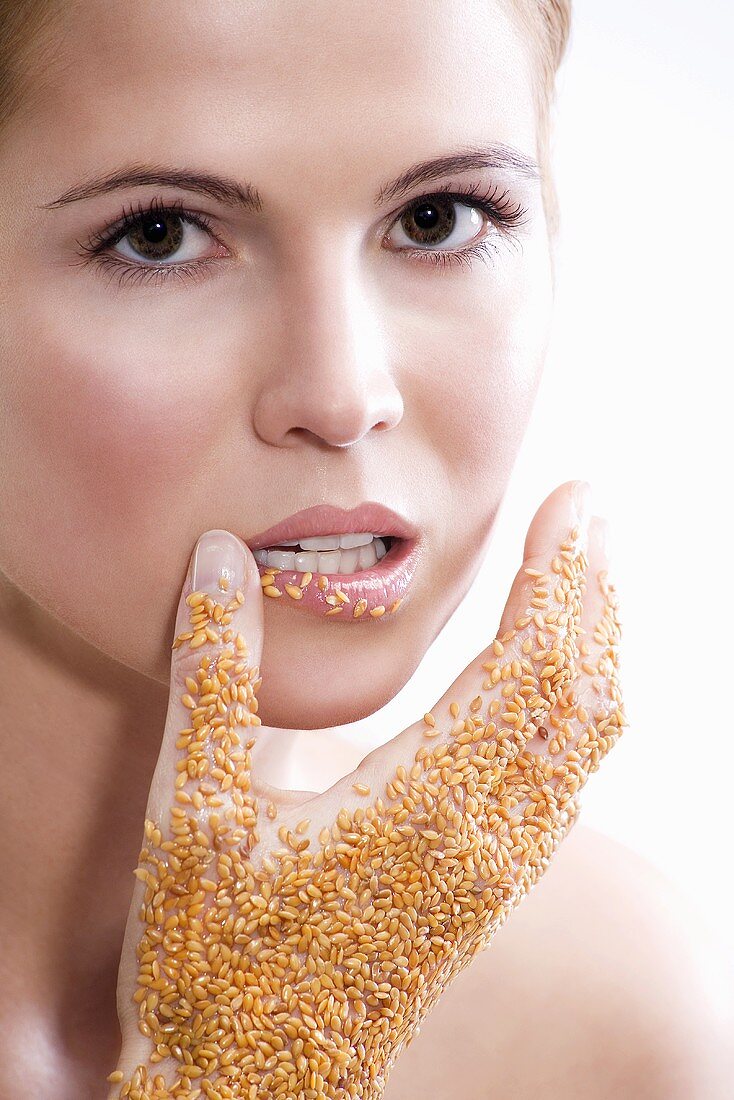 Woman with sesame on hand, close-up