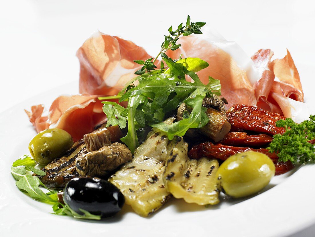 Plate of antipasti: pickled vegetables and raw ham