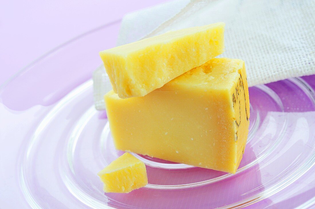 Pieces of Parmesan on glass plate