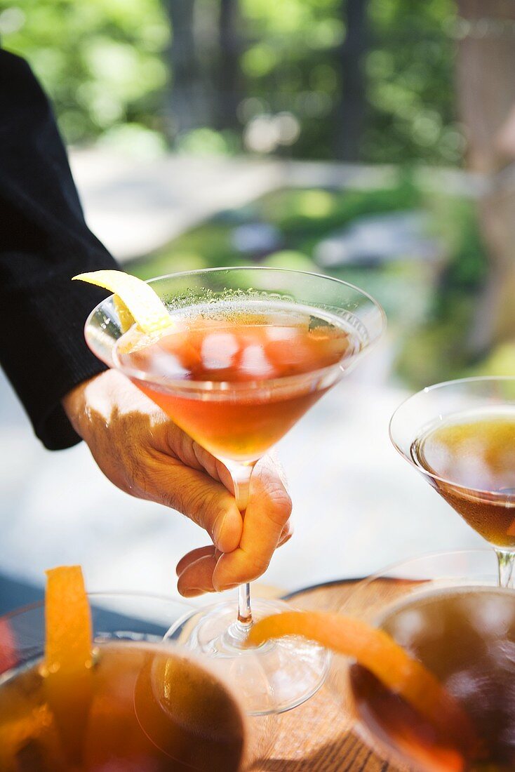 Hands Holding Cocktails; Outdoors