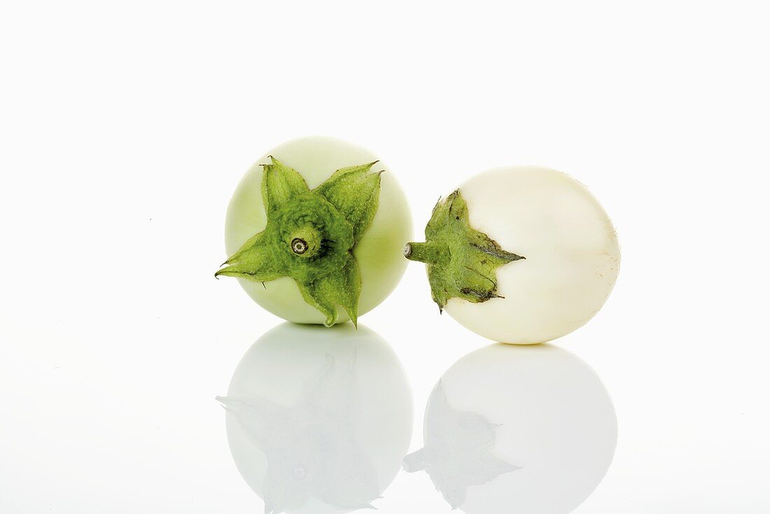 Two white baby aubergines