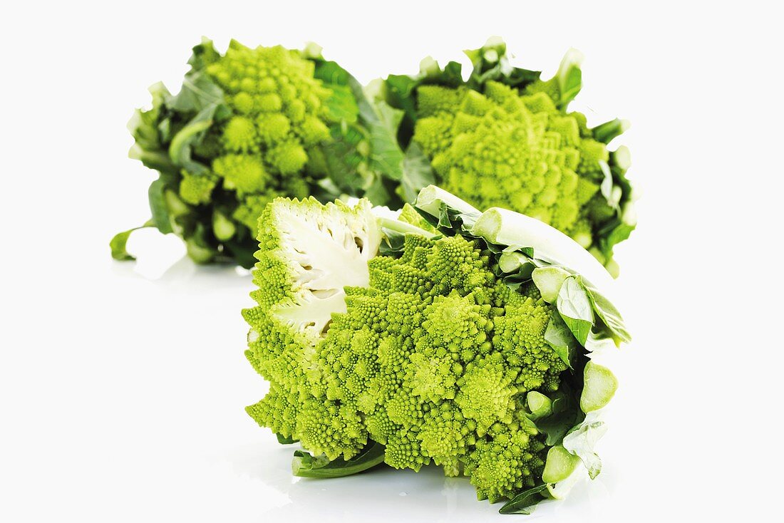 Romanesco broccoli, two whole and one halved