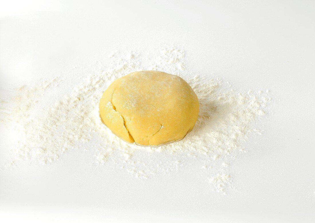 Shortcrust pastry dough on floured surface