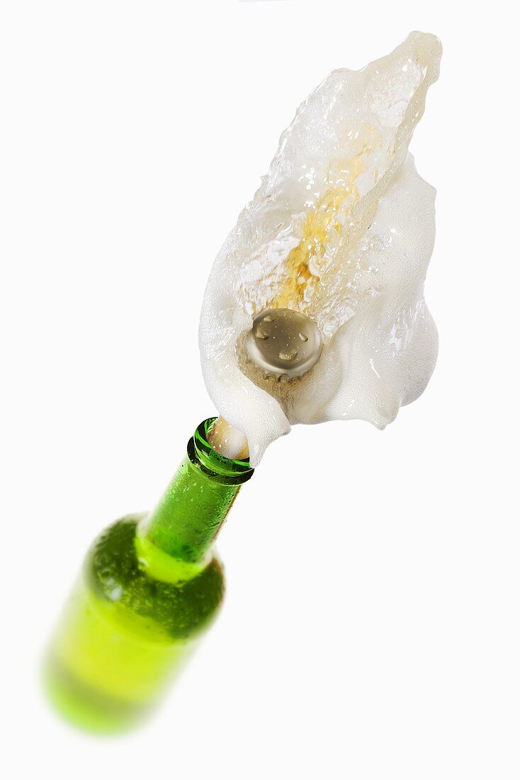 Beer splashing out of green bottle