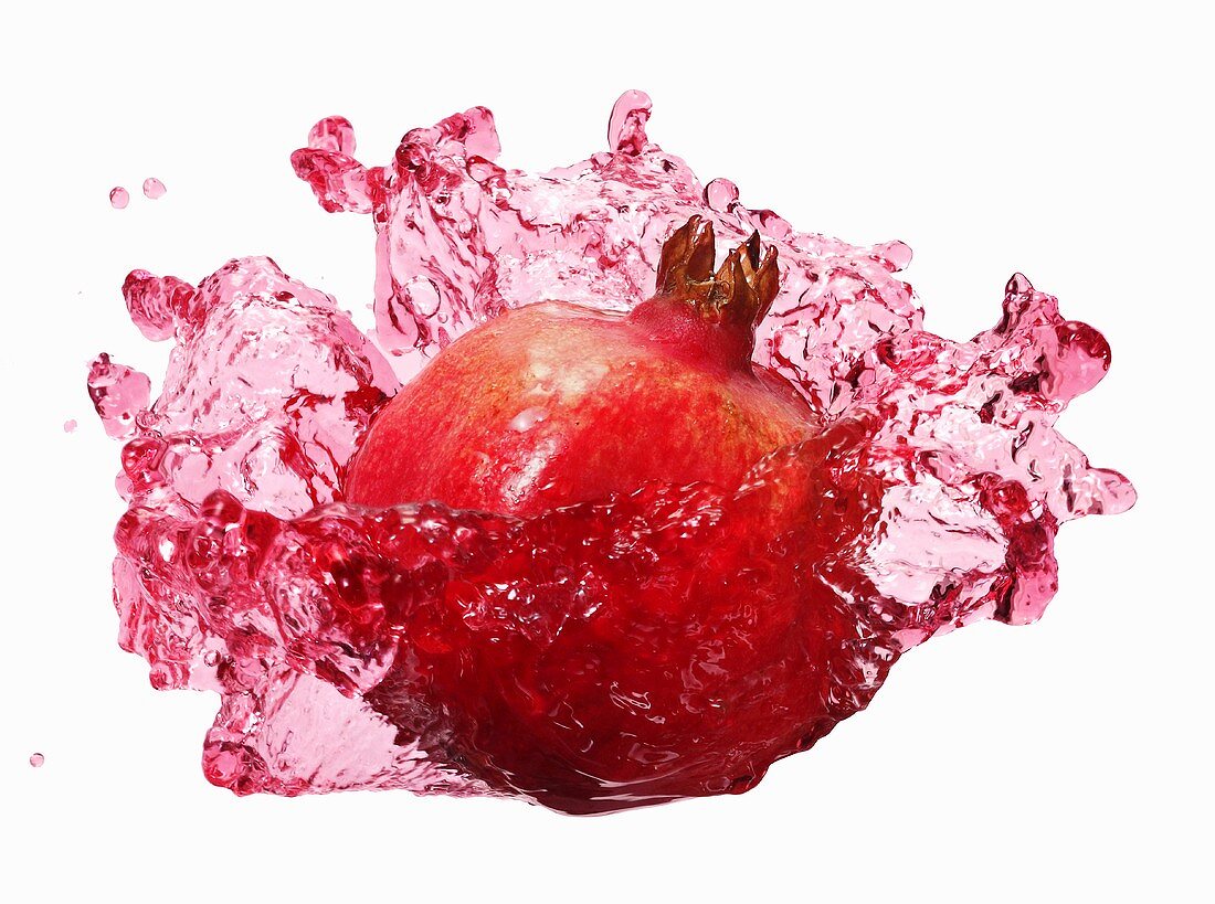 Pomegranate with splashing pomegranate juice