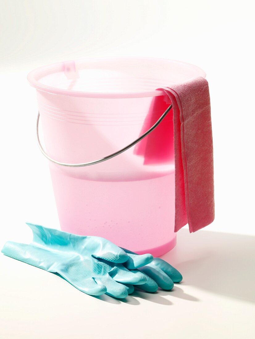 Pink cleaning bucket with rubber gloves