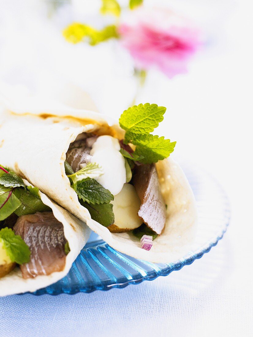 Wraps filled with herring, potatoes and sour cream