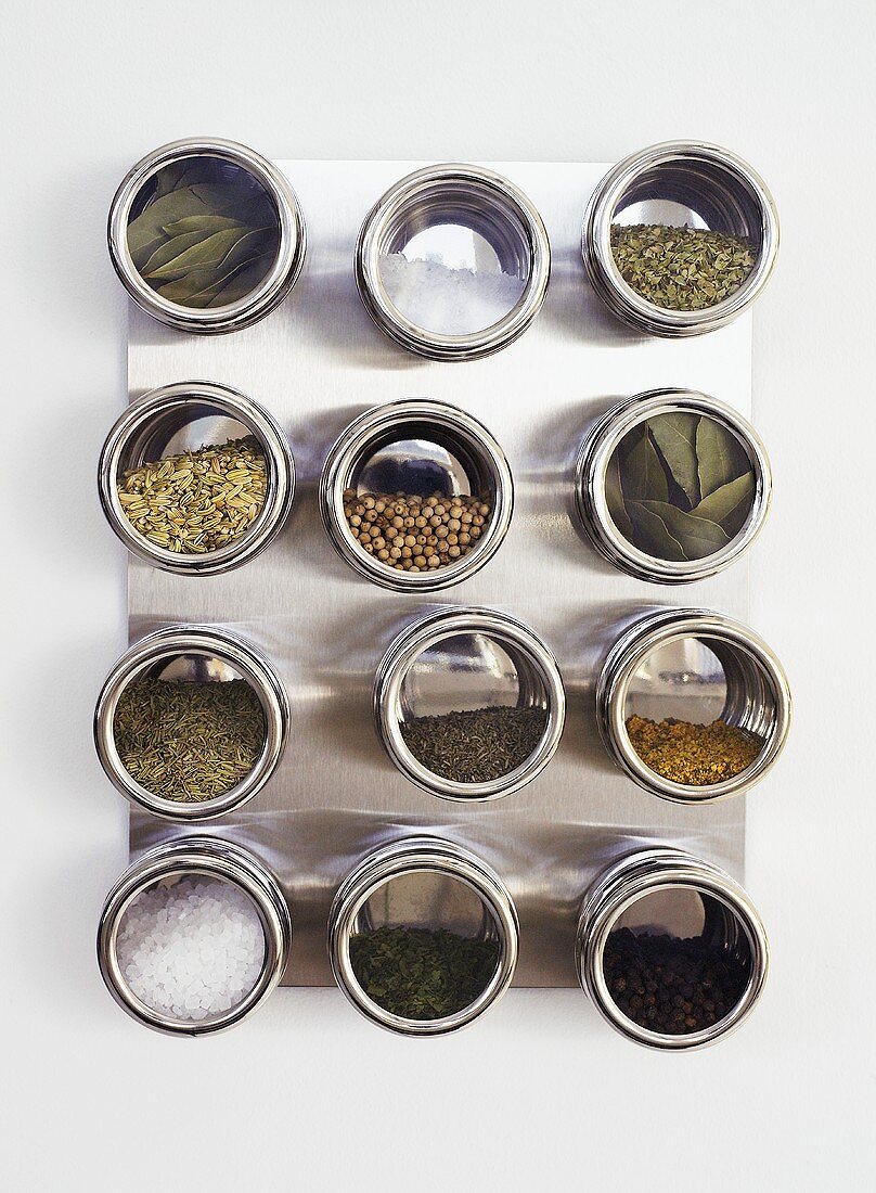 Assorted spices in screw-top jars (overhead view)