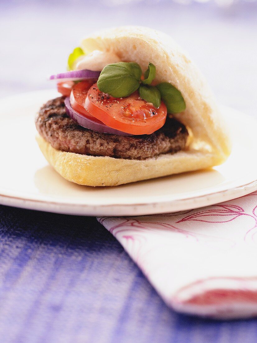 Burger, onion and tomato in ciabatta