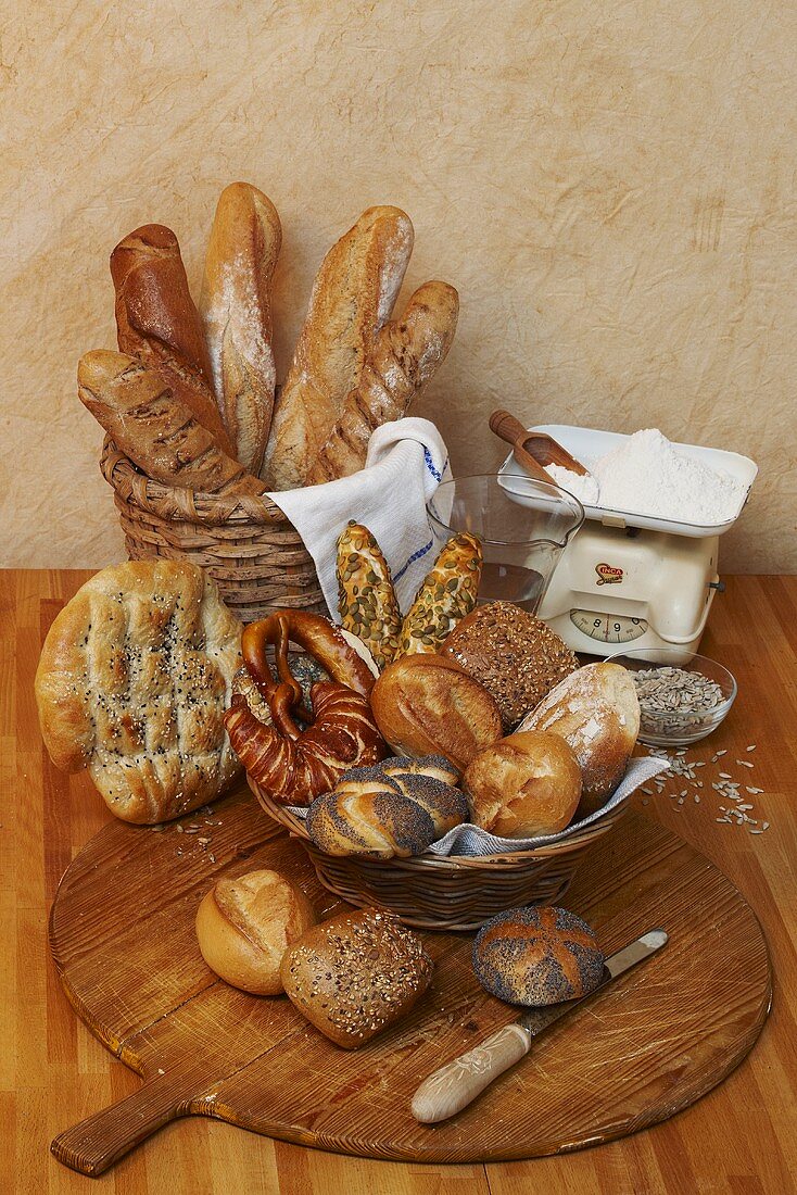 Various types of bread and bread rolls, flour on scales
