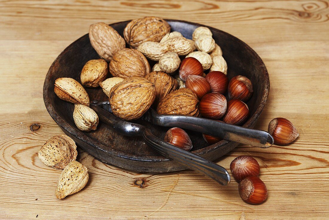 Assorted nuts in dish with nutcracker